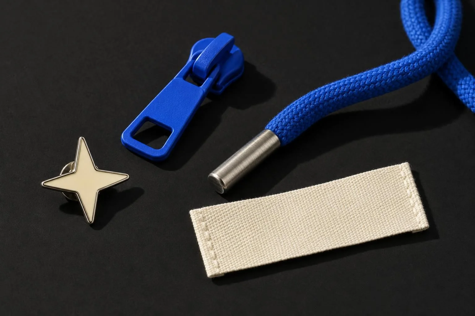Custom hardware: enamel star pin, zipper pull, aglet, woven label